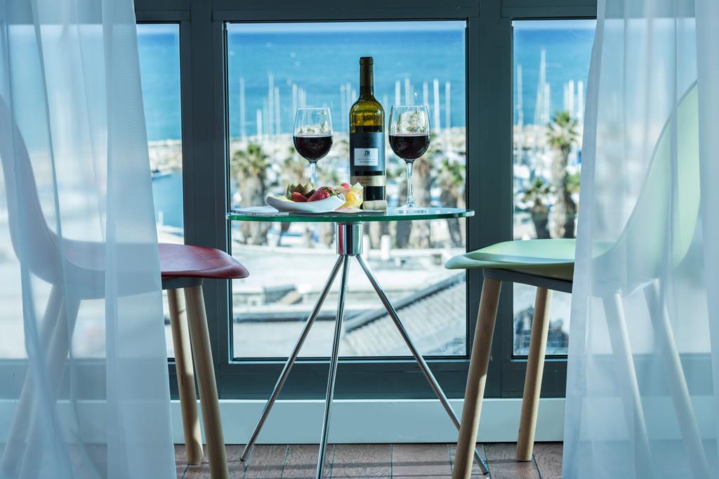 A table for two by the window, overlooking the Tel Aviv marina